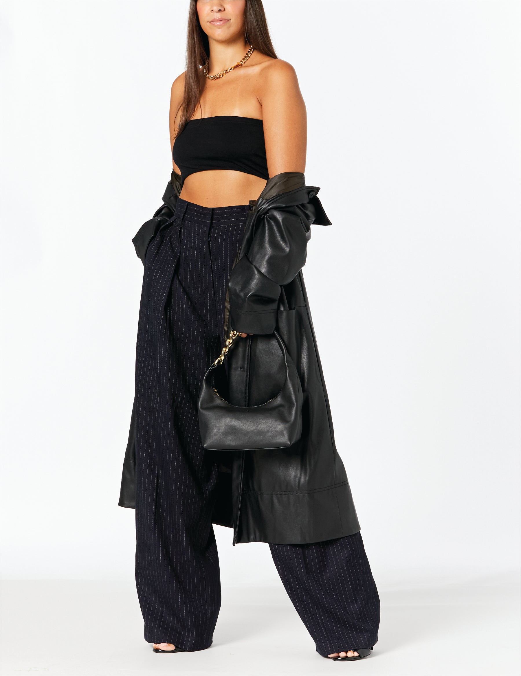MAX+min Randi black leather hobo bag worn on the shoulder.