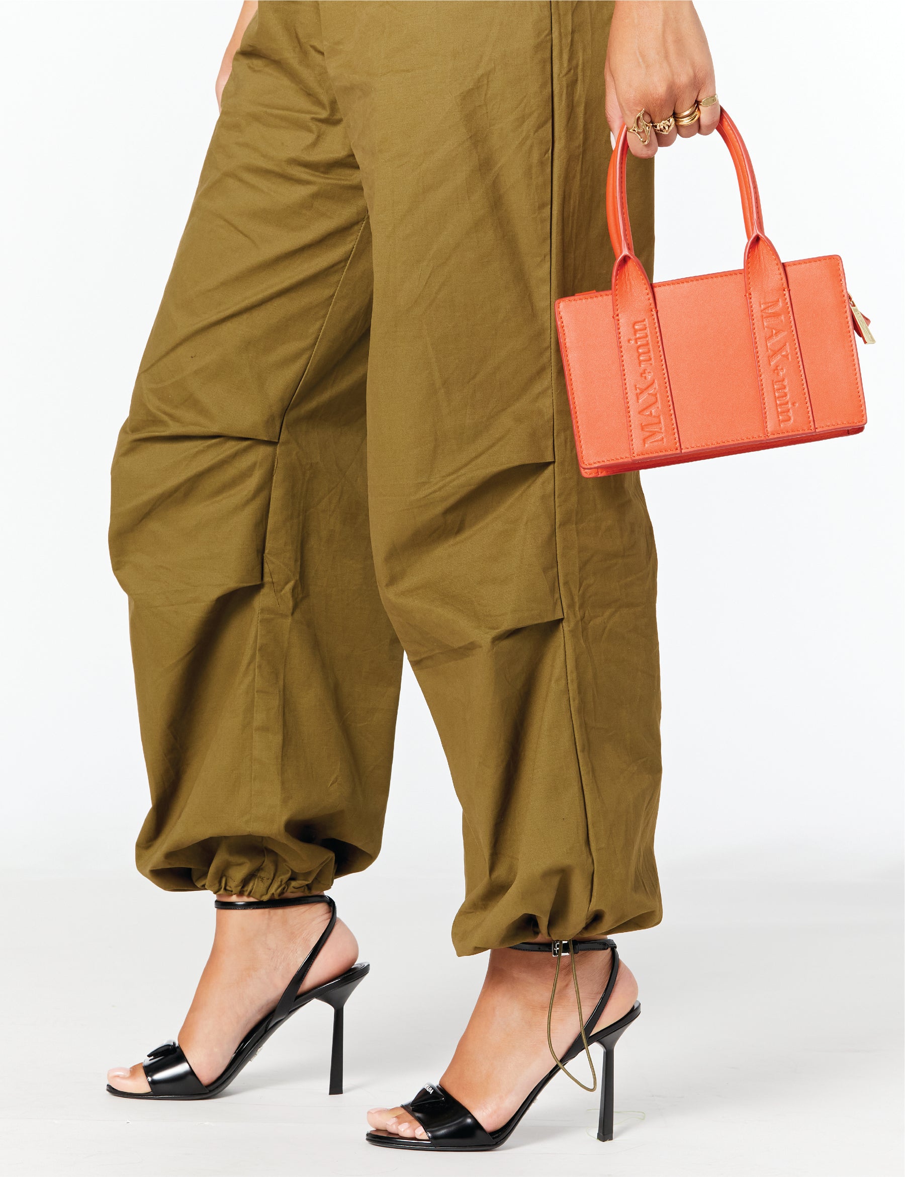 MAX+min MIMI Flame orange leather crossbody bag styled on body.